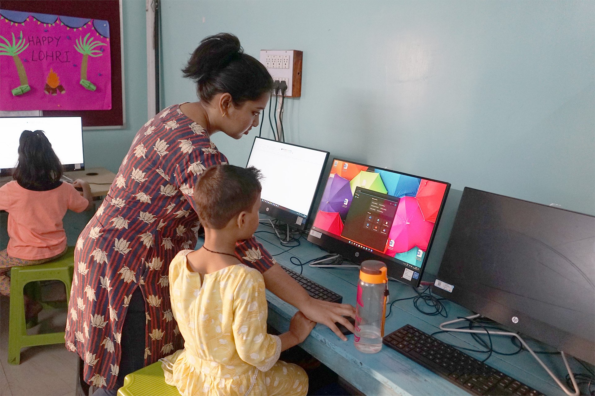 Street-children-helping-kid-use-PC